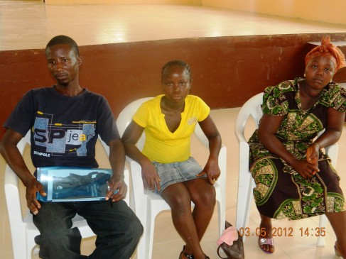 Three of the beneficiaries of the Liberian Social Cash Transfer Program including, 19-year-old Hawa, mother of two children, seated in the middle